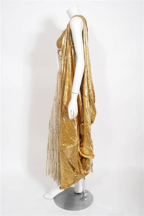 Gold fringe gown on stage with Swarovski crystals