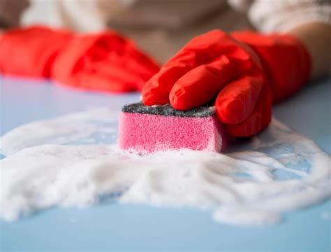 close-up of a damp scouring pad removing lint from a wool blanket